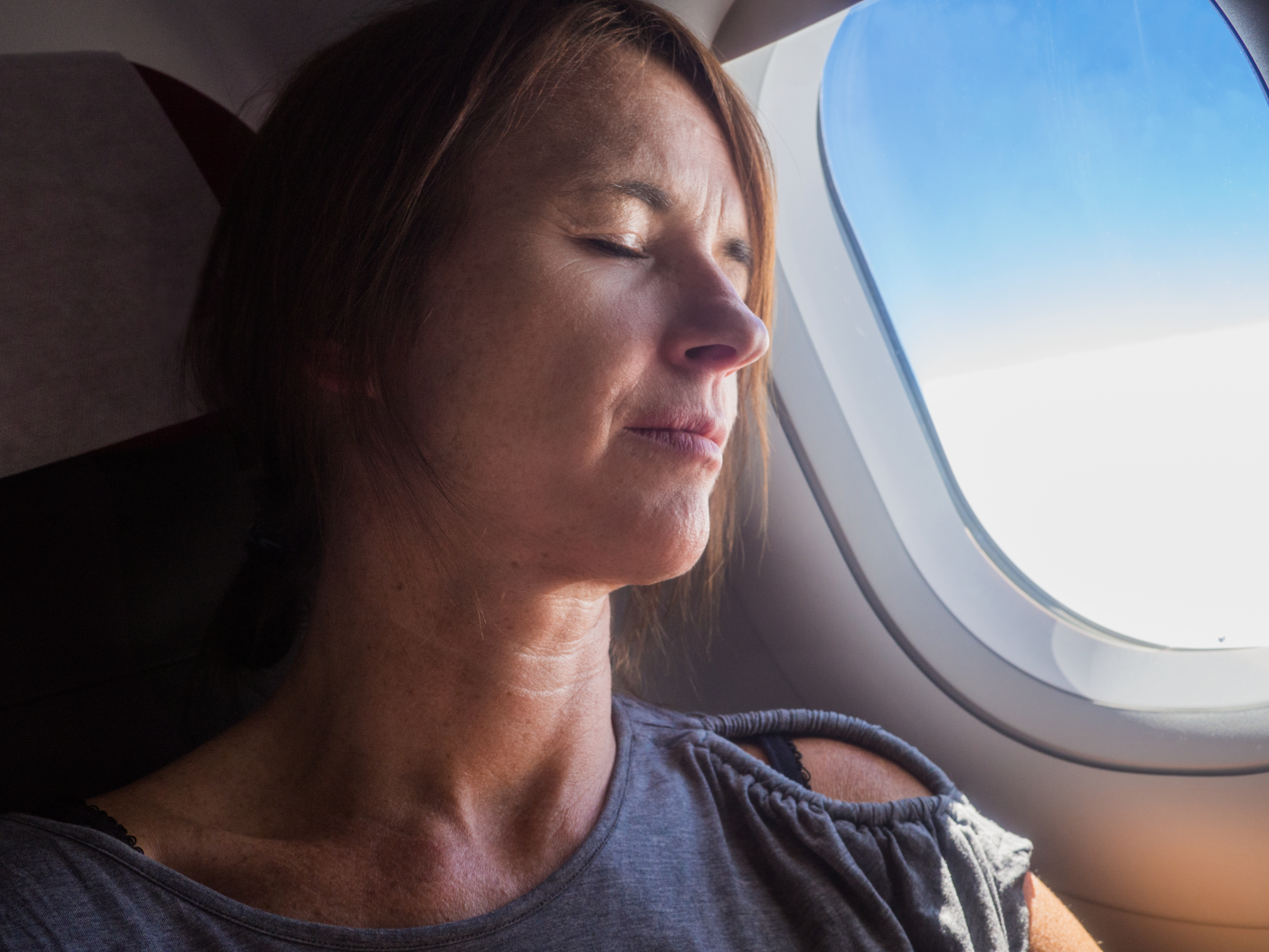 Woman is sleeping in the aircraft