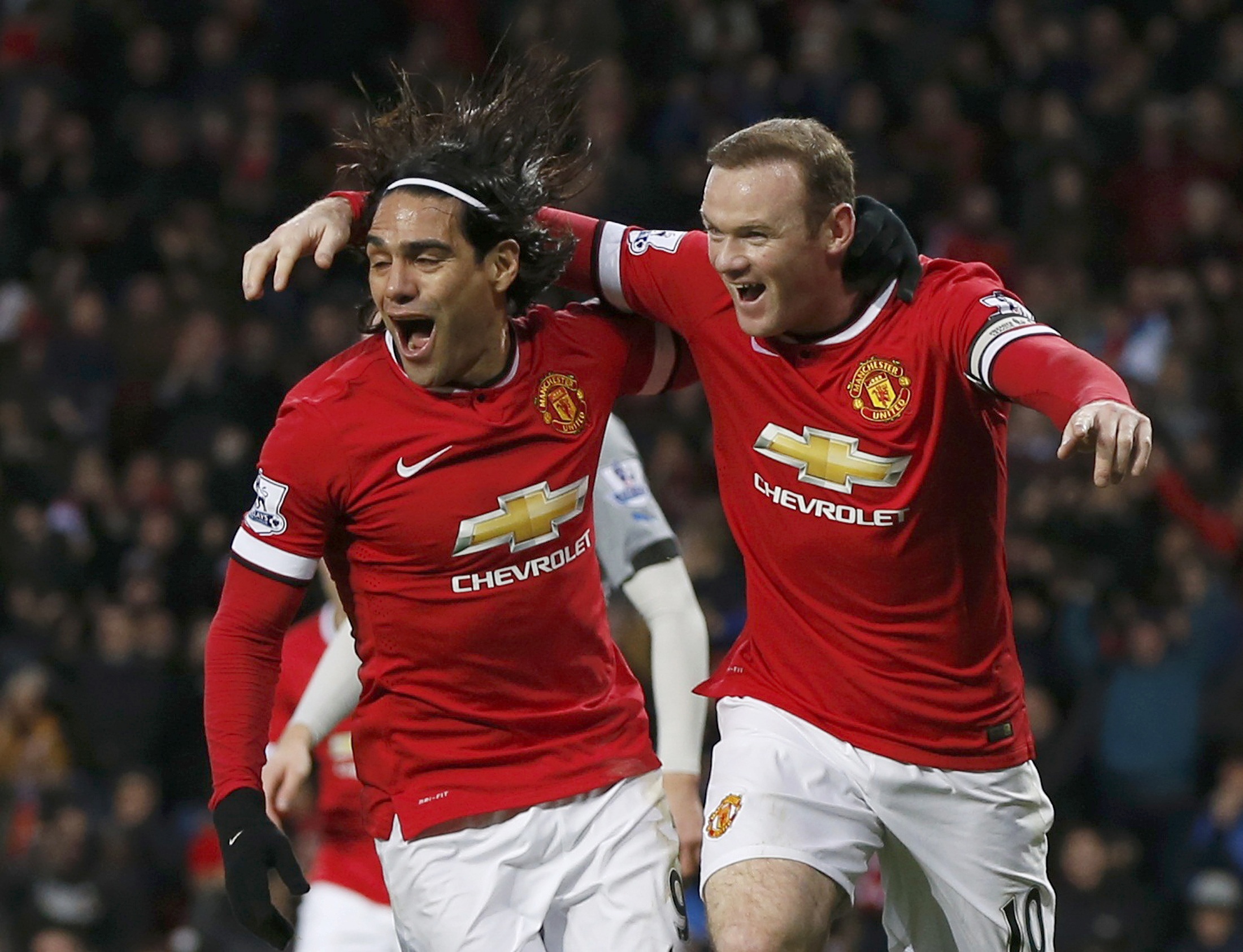 Manchester United's Wayne Rooney celebrates after scoring a goal against Newcastle with team-mate Radamel Falcao during their English Premier League soccer match at Old Trafford in Manchester