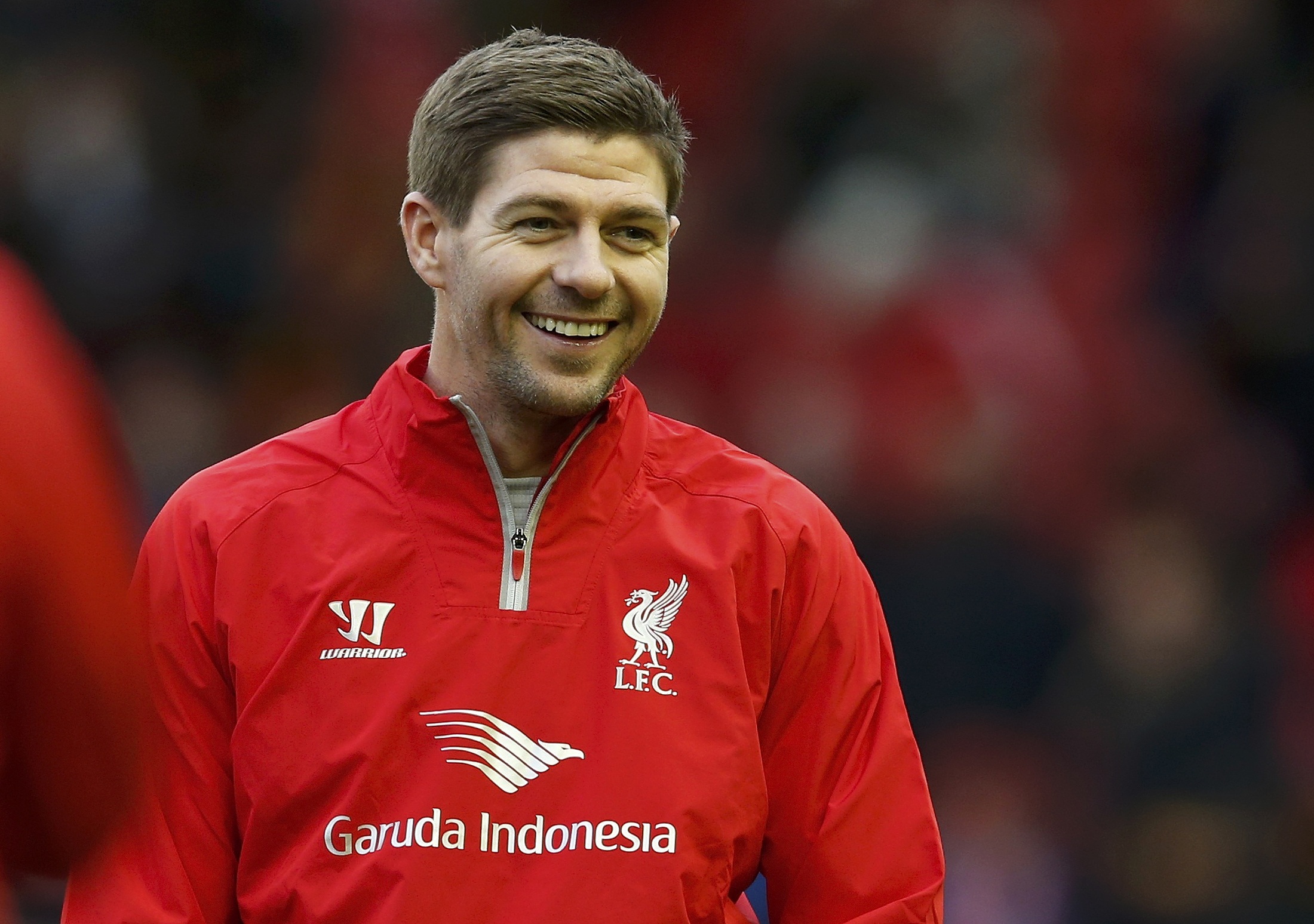 Liverpool's Steven Gerrard smiles during his warm up before his team's English Premier League soccer match against Sunderland at Anfield in Liverpool